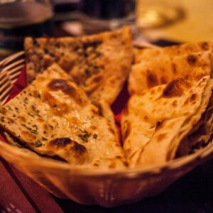 Close-up of traditional Indian flatbreads in a basket, perfect for a delicious meal.